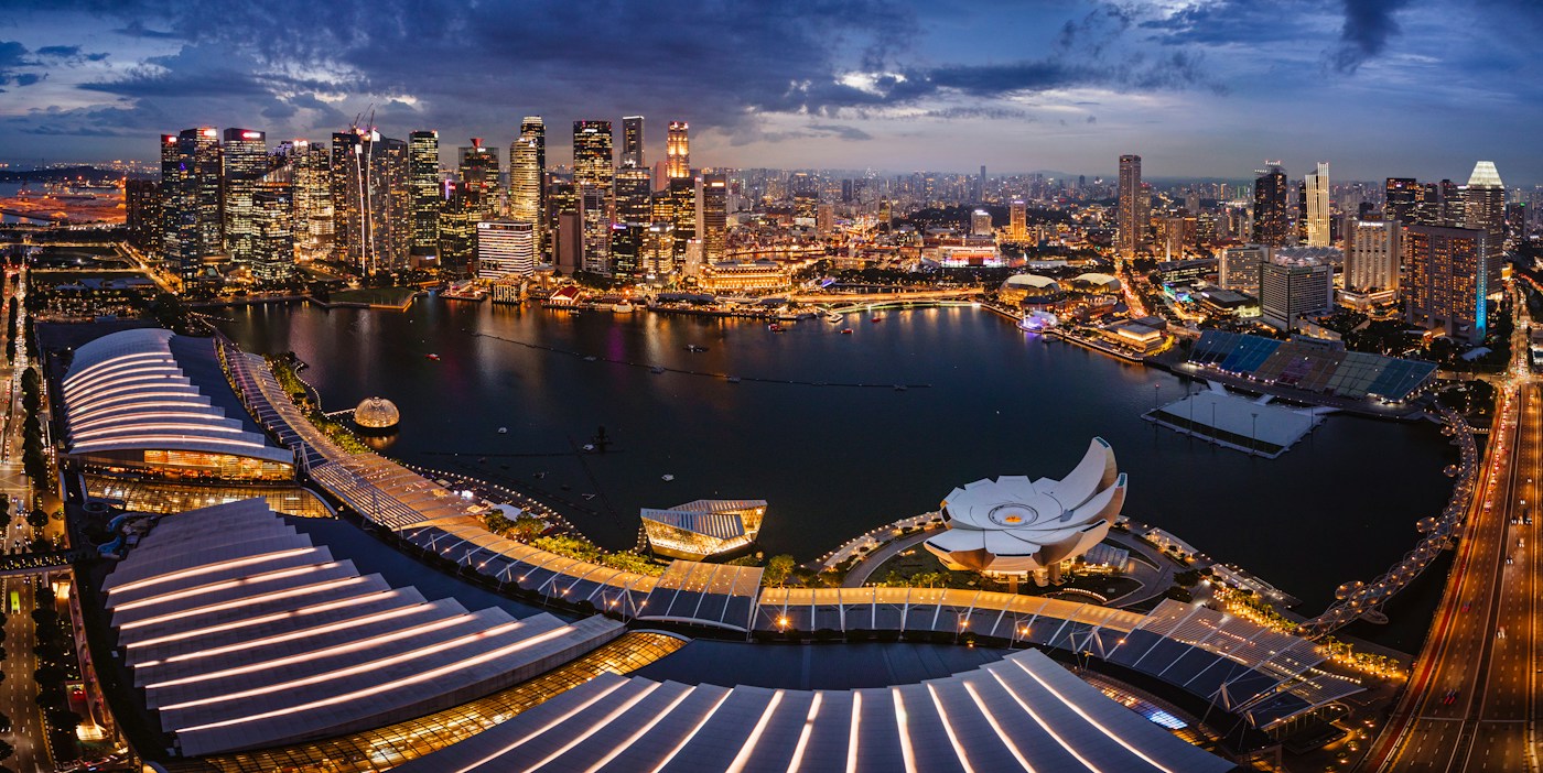 Singapore’s Marina Bay at night, with city lights reflected on the water